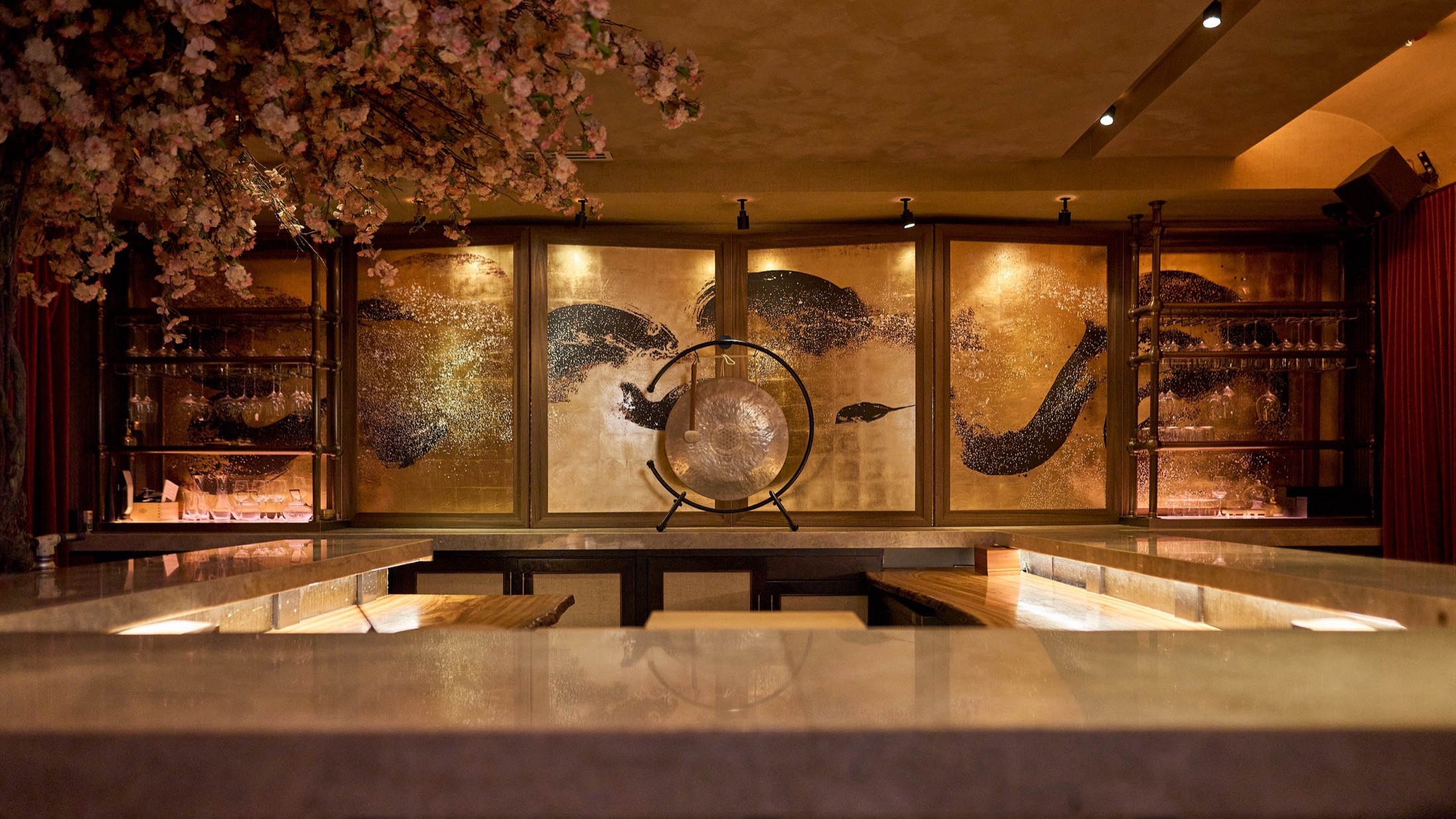 Gold-leaf restaurant bar with a ceremonial gong