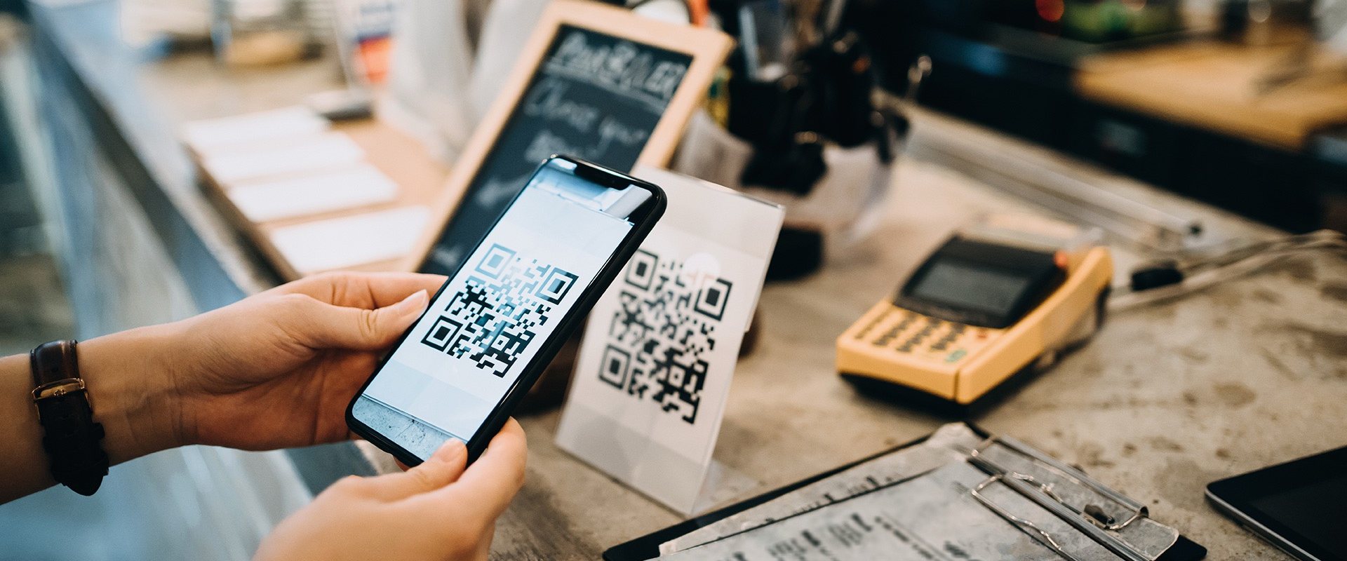Scanning a QR code at a shop counter