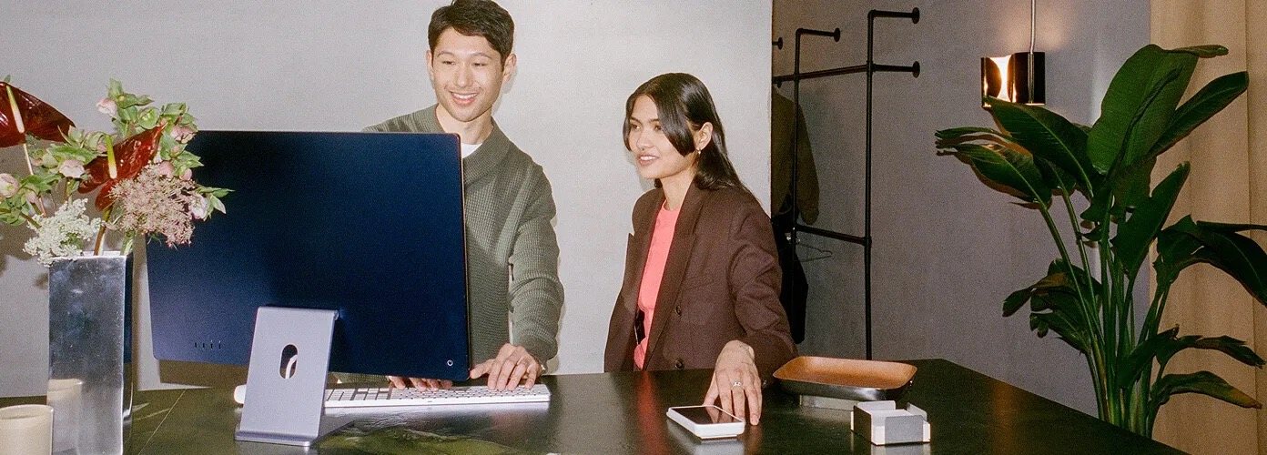 Two people behind a shop counter