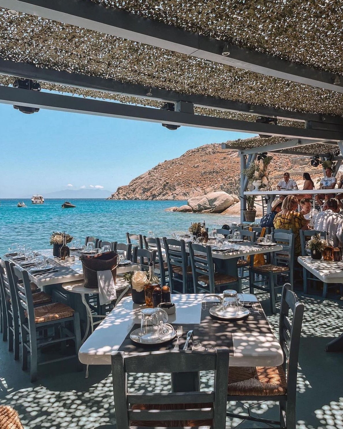 A seaside taverna with tables by the water